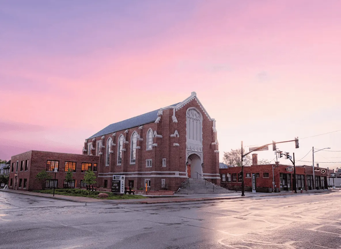 The Work Club building at 16400 Detroit Avenue: a brick former church at sunset on the corner in Lakewood.